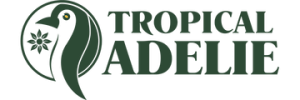 The brand logo for Tropical Adelie, featuring a penguin and floral leaf design on the left, and the brand name text on the right.