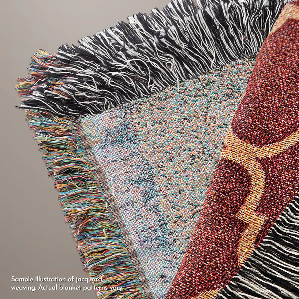 Tropical Adelie Wandering Warrior Blanket Display Close-up detail of a jacquard woven blanket showing the intricate interlacing of multi-colored cotton threads and the resulting textured pattern and fringed edges.