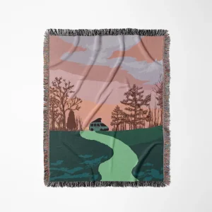 Tropical Adelie "Overland Roamer" woven throw blanket featuring a vintage-style illustration of a green camper van parked under a pink and peach sunset sky, surrounded by pine trees with a winding path in the foreground.