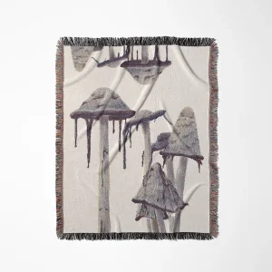 Shaggy mane mushroom blanket with gray-purple mushroom illustrations on an ivory background and multicolored fringe.