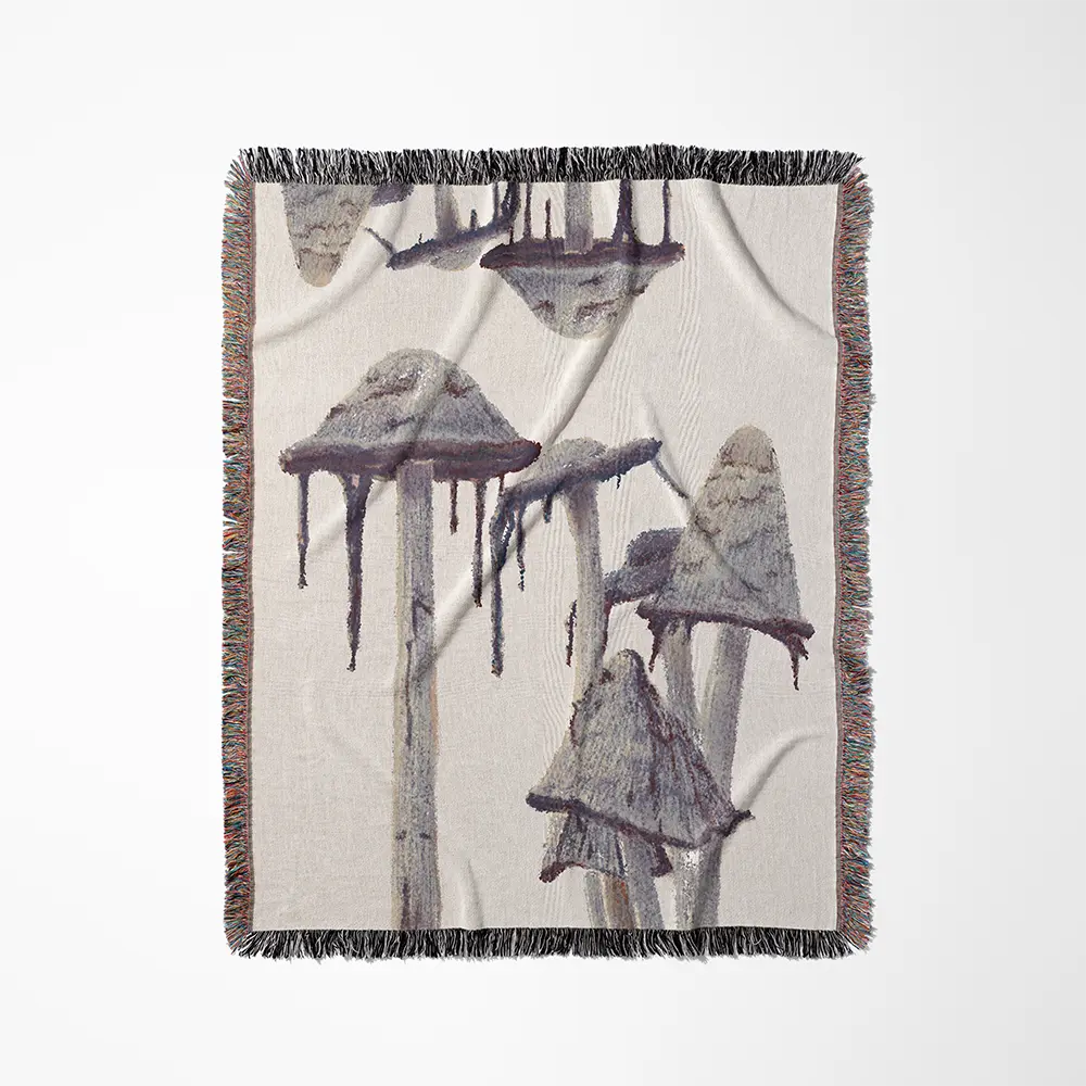 Shaggy mane mushroom blanket with gray-purple mushroom illustrations on an ivory background and multicolored fringe.